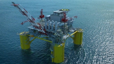 Digital visualisation of the Sparta offshore oil and gas platform showing a large floating structure at sea supported by four yellow columns, with cranes, processing equipment, and a helipad on the top deck, surrounded by open water.