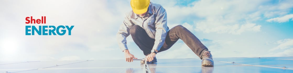 A worker doing maintenance on solar panel