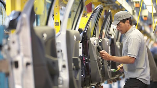 Employee working on car production line