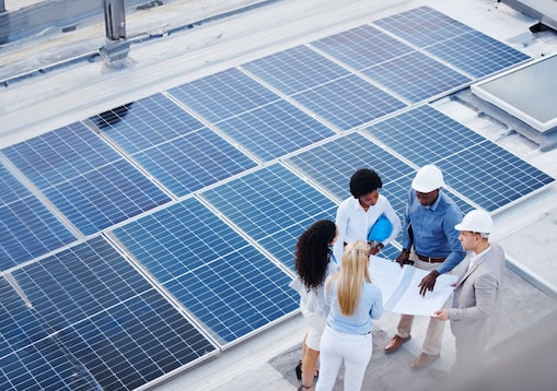 Engineering designers next to solar panels