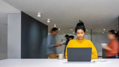 Lady wearling yellow jumper in busy office