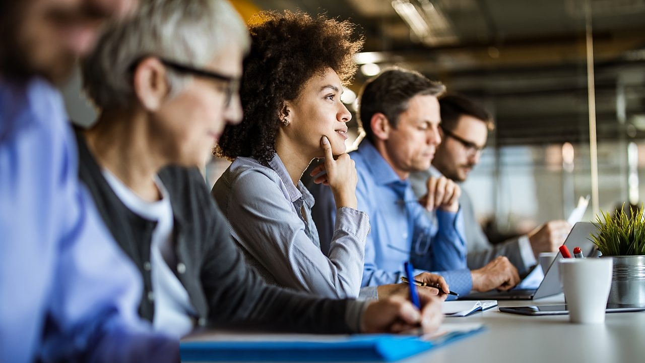 Business People Sitting in an Office Building Having a Meeting
