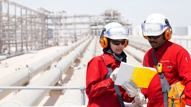 A field operator supporting a young Qatari Engineer