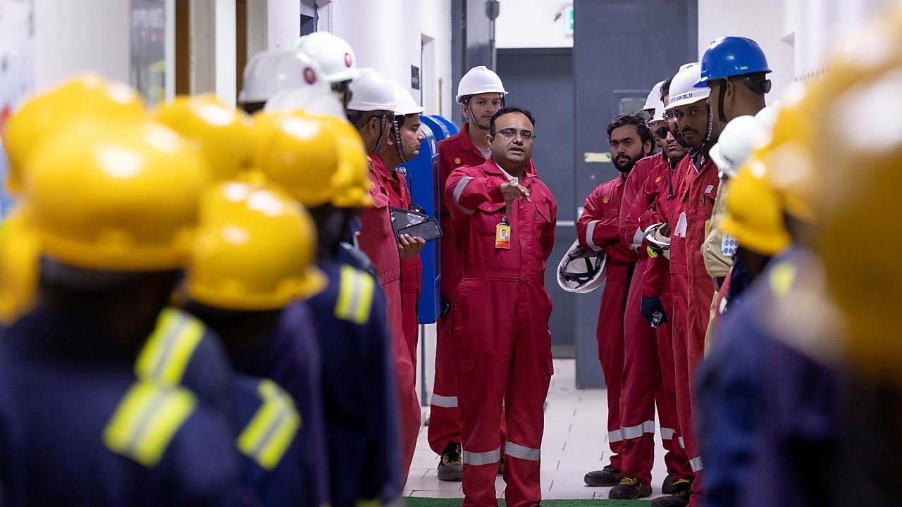 Shell employee in orange uniform and white hard hat