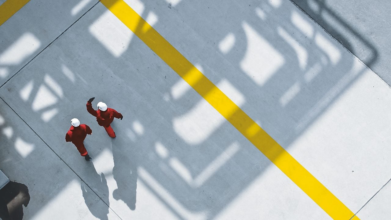 Two people walking in site