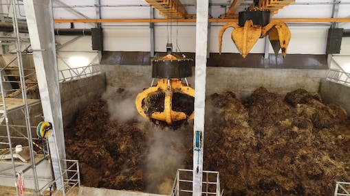 Machinery collecting cow manure for processing in an anaerobic digester to produce biogas/biomethane
