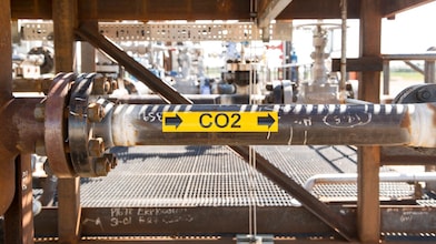 image shows a Carbon Capture and Storage pipe with a sticker on it indicating the direction of flow of the CO2 within in.