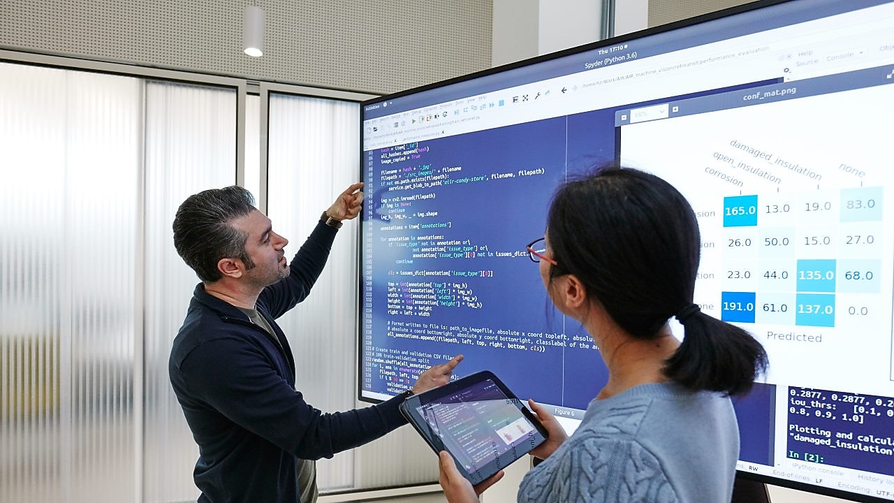 Data Scientists working with artificial intelligence code