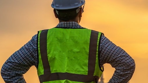 Engineers looking at site in oil and gas refinery or Petrochemical factory during sunrise.