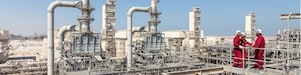 An operator operates a valve at an industrial facility