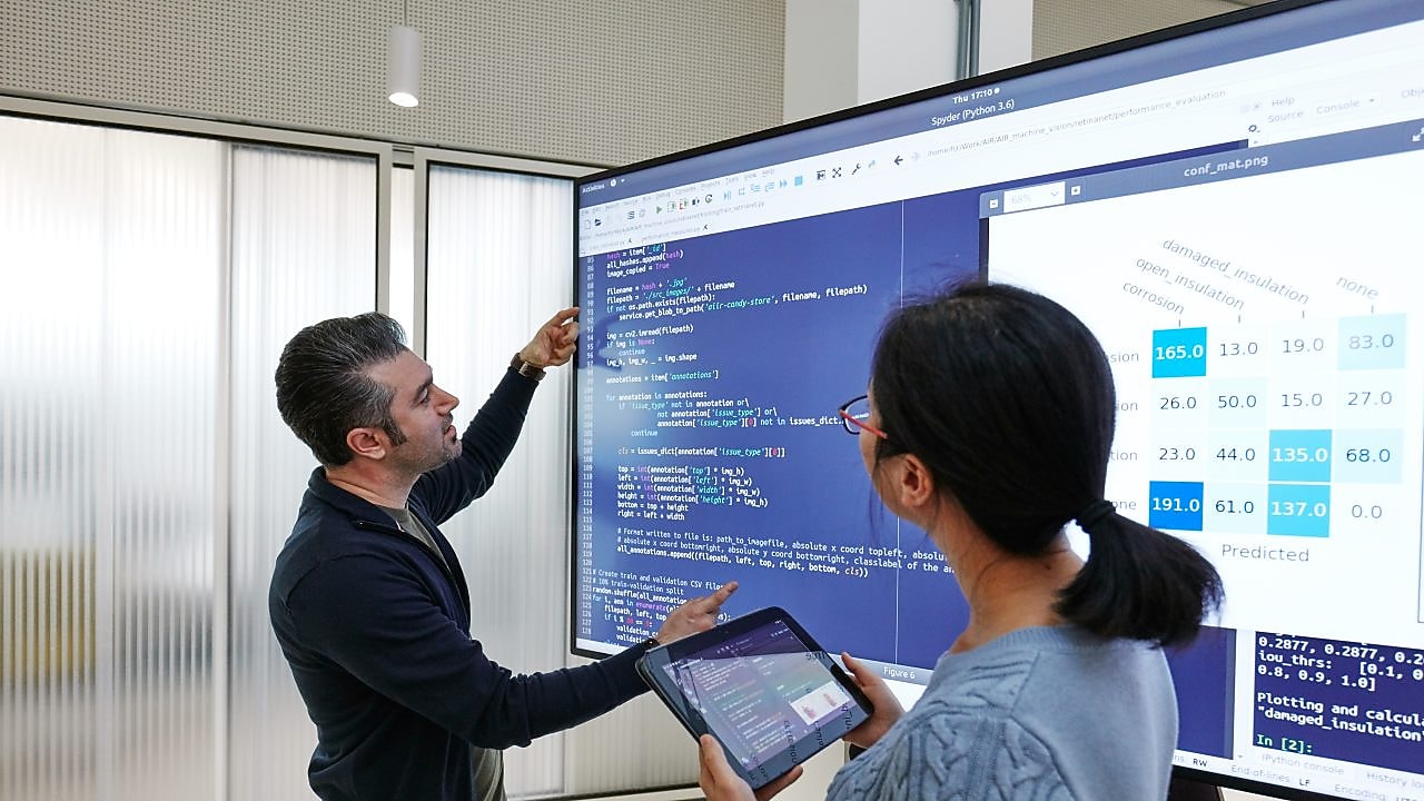Data Scientists working with artificial intelligence code