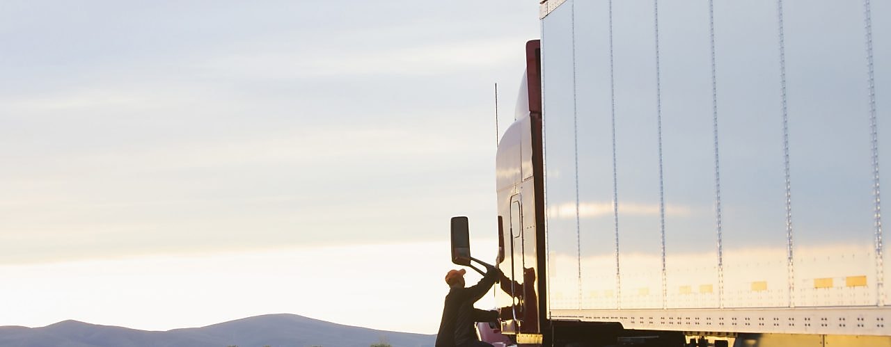 man getting on truck