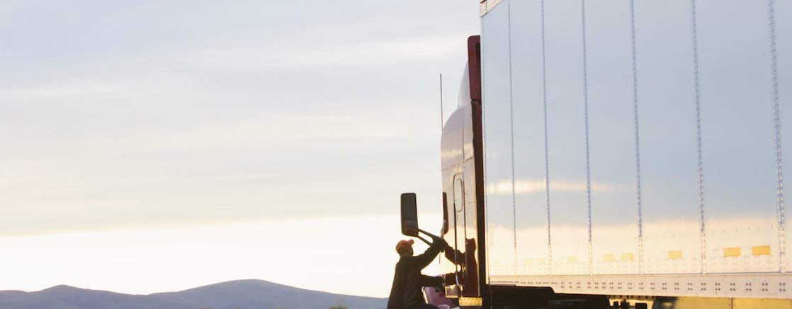 man getting on truck