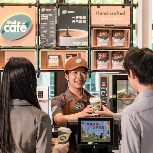 Woman recharging electric car