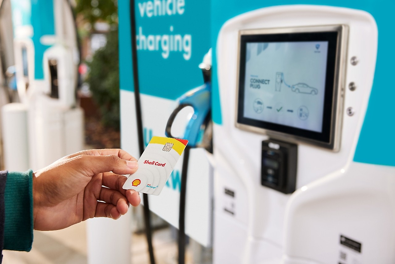 Woman recharging electric car