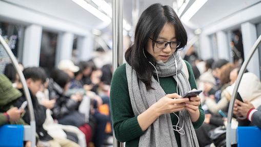 Women in train looking at her smartphone