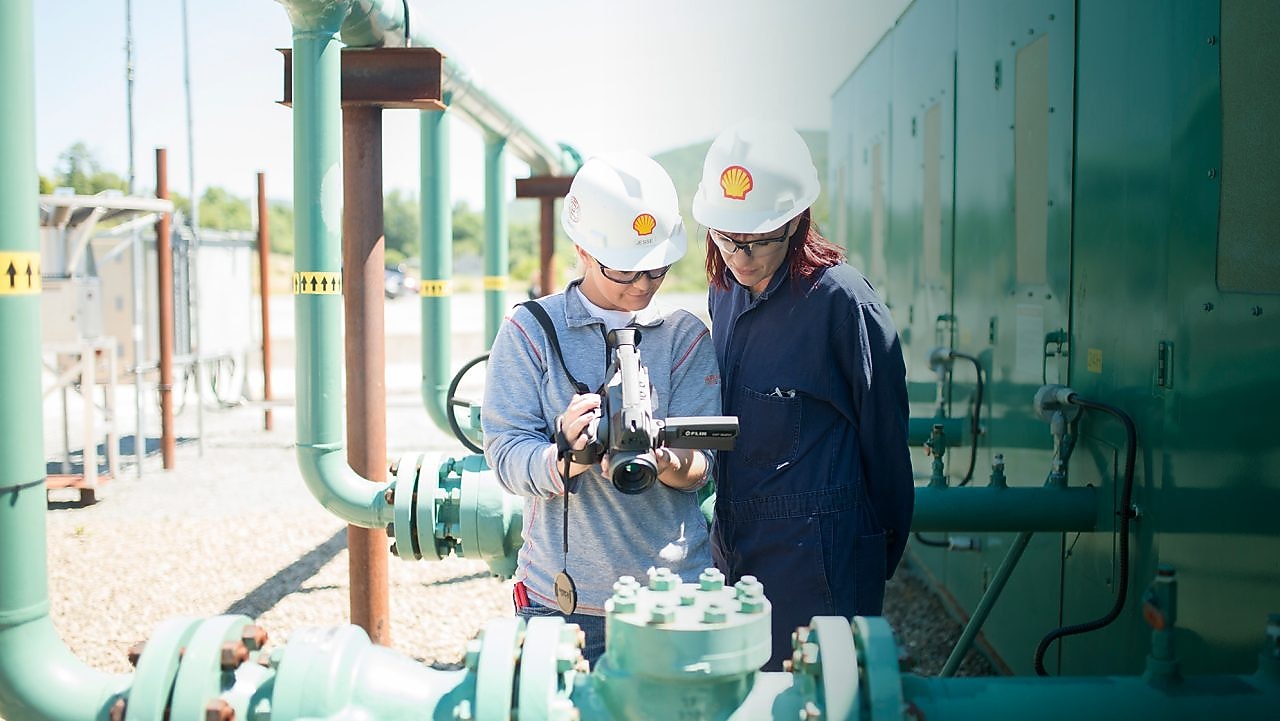 Two women testing Methane Emissions Leak Detection Stock