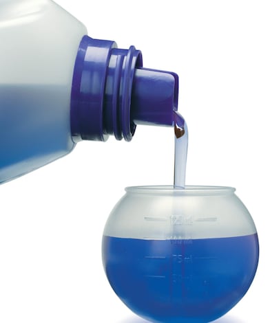 Fabric detergent pouring from bottle