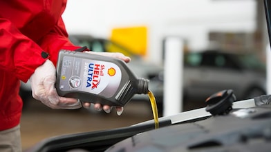 Shell Helix Ultra lubricant being poured into car engine