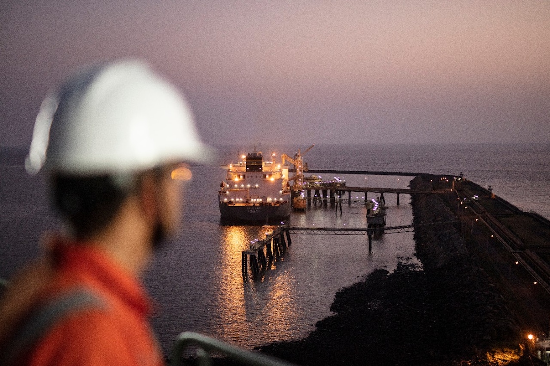 worker looking at Liquified Natural Gas ship
