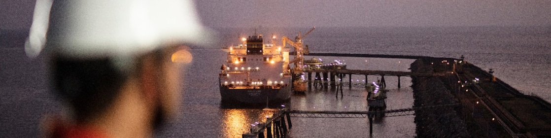worker looking at Liquified Natural Gas ship
