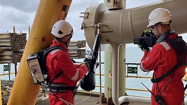 A group of men wearing red overalls and white helmets