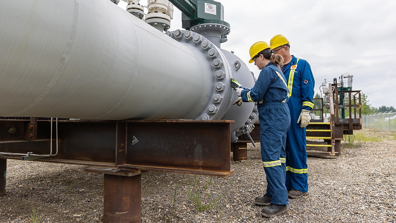 Employees in yellow helmet inspecting