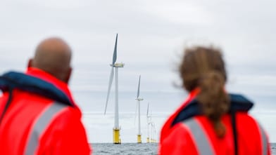 A man and women looking at the egmond aan zee wind farm