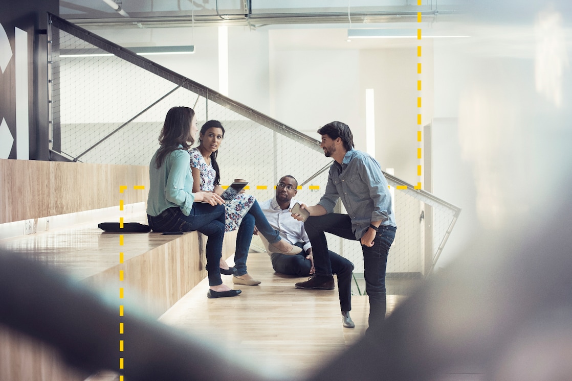 Young business people discussing, sitting on stairs Image reference below.