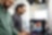 Male colleagues discussing while standing in office Image reference below.