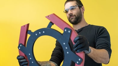 Engineer holding a prototype.