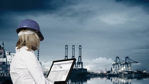 women holding aptop in hand working at plant side