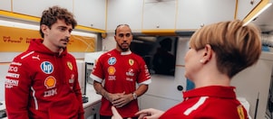 Shell scientists and Scuderia Ferrari HP drivers conversing in the Shell Trackside Laboratory at a Grand Prix circuit