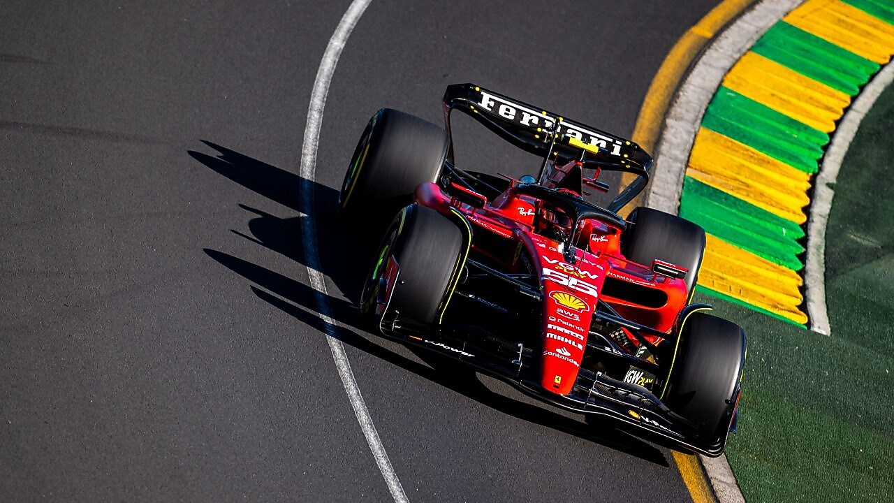 Side view of the F22 Ferrari Formula 1 car being driven by Carlos Sainz round a corner