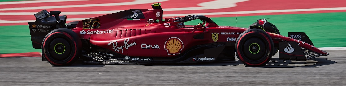 Side view of the F22 Ferrari Formula 1 car being driven by Carlos Sainz round a corner