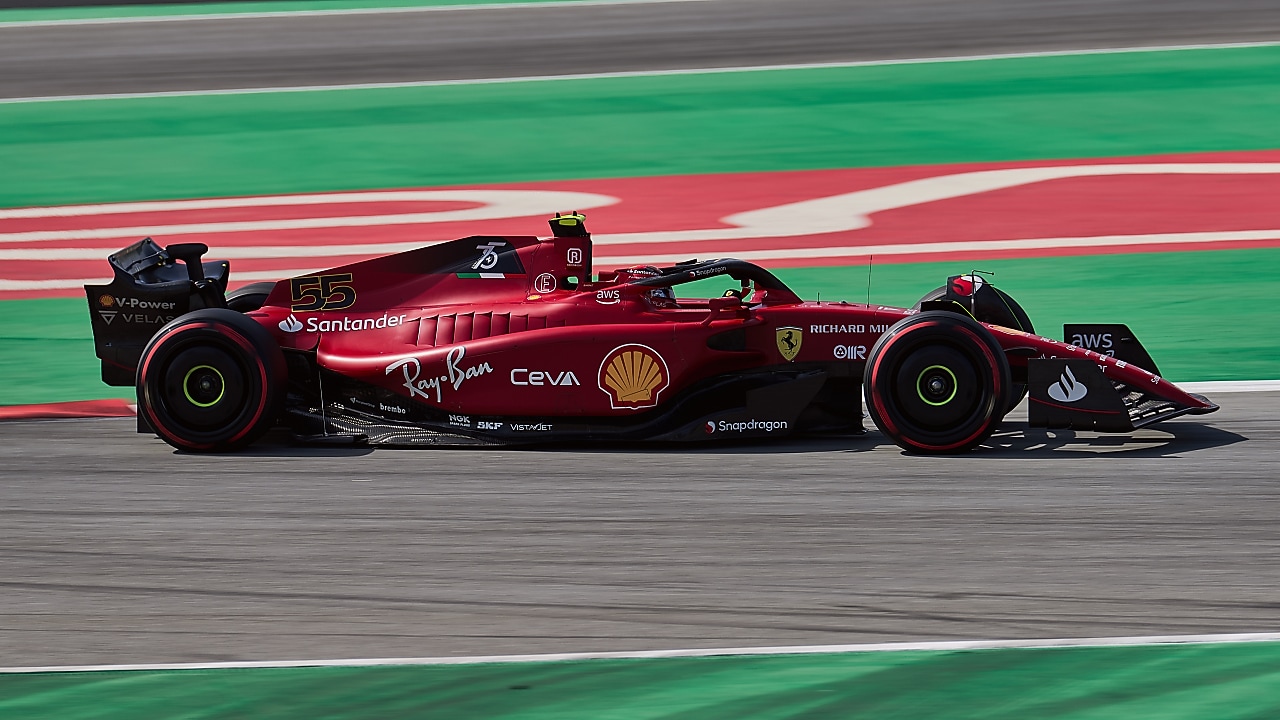 Side view of the F22 Ferrari Formula 1 car being driven by Carlos Sainz round a corner