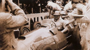 Driver José Froilán González in his Ferrari 375 F1 during a refueling pit stop.
