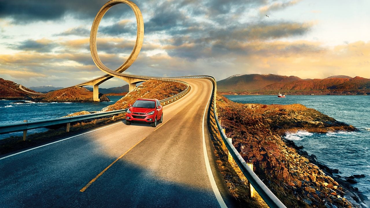 Car on the road with surroundings of sea and mountains