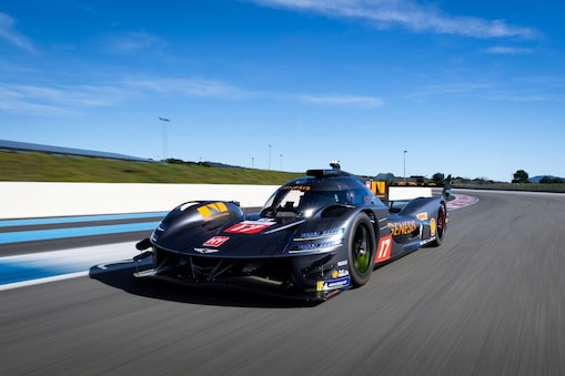 Genesis Magma Racing hypercar driving on a racetrack.