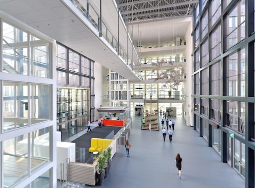 In the image is possible to see a big atrium with glass walls. That’s the Energy Transition Campus Amsterdam, formerly one of Shell’s Technology Centres.