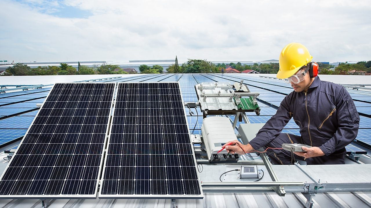 Man working on Rooftop Solar Panels
