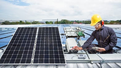 Man working on Rooftop Solar Panels