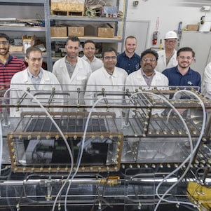 A group of people standing in a room at Shell TechWorks workshop