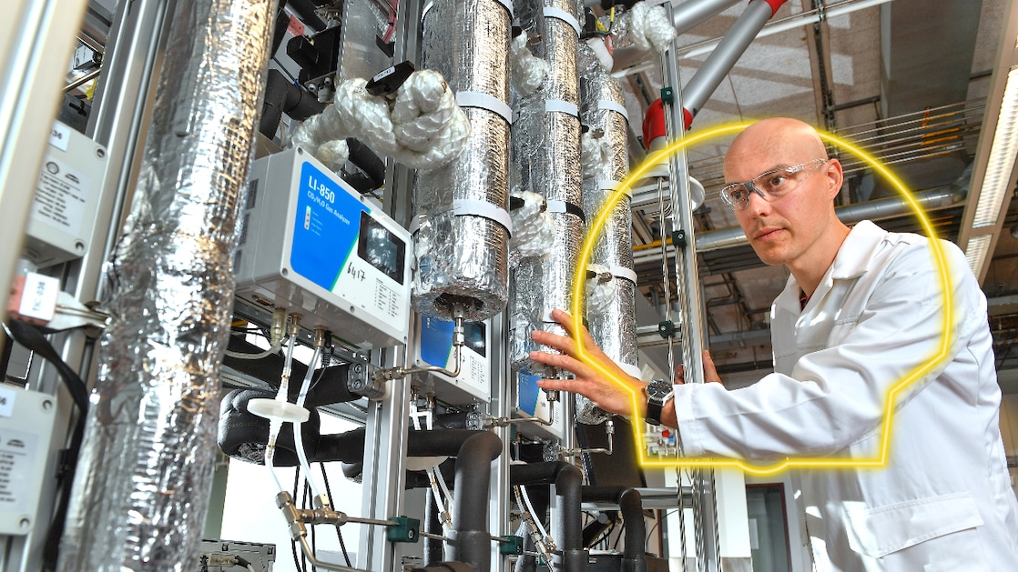 a man touching a machine in a lab