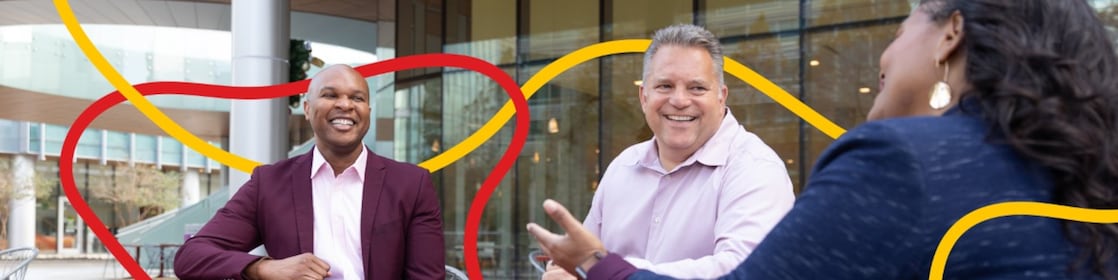 Three people chatting and smiling