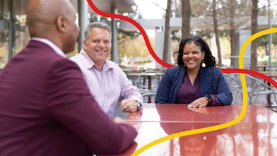 Three peolpe chatting and smiling