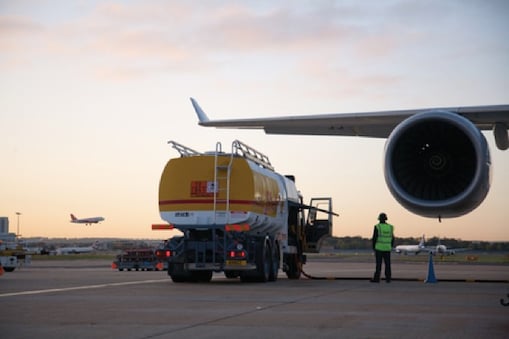 Shell fuel tanker by wing of Airbus A380 on tarmac
