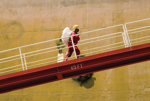 Worker walking up ramp of LNG facility