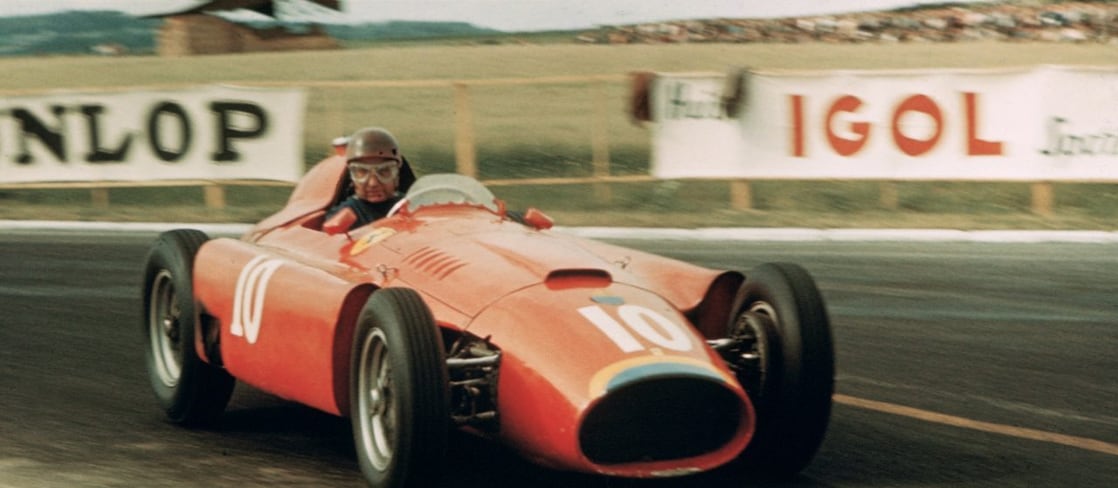 Old style red racing car on racing track