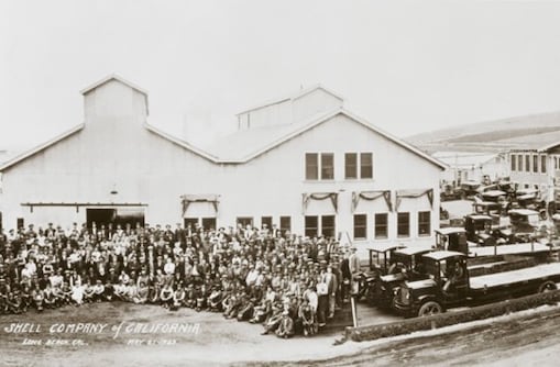 Black and white photo of staff and vehicles